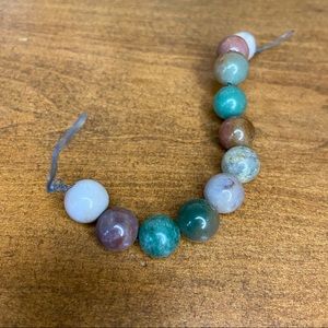 String of 11 stone beads from China